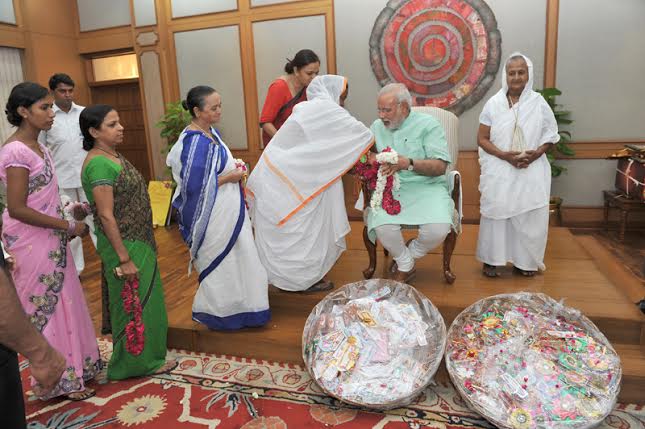 Women, children tie Rakhi on PM's wrist on Raksha Bandhan