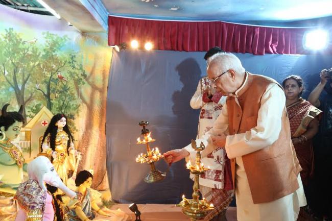  Governor of West Bengal Shri Keshari Nath Tripathi is offering an arati to the Durga idol