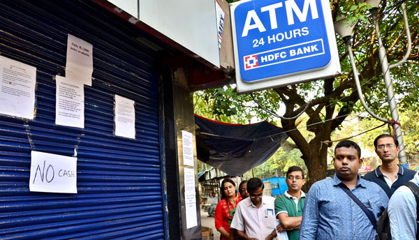 Kolkata: People queue in front of banks, ATMs to get cash
