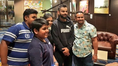 Virat Kohli poses with fans after reaching Australia