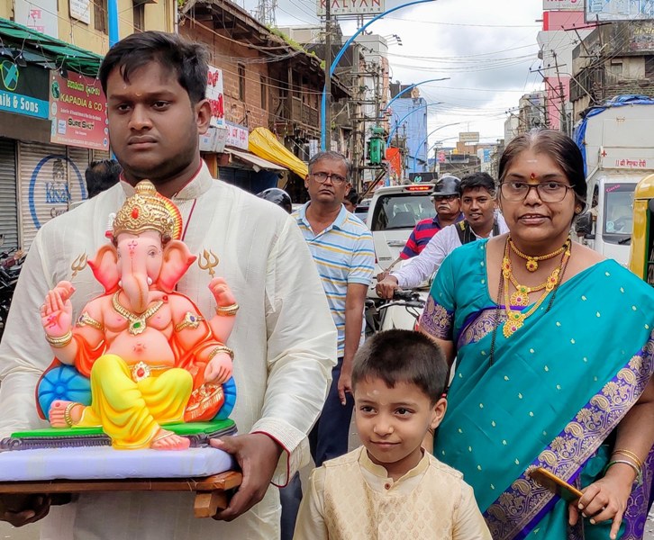 People carry Lord Ganesh to their home on Ganesha Chaturthi