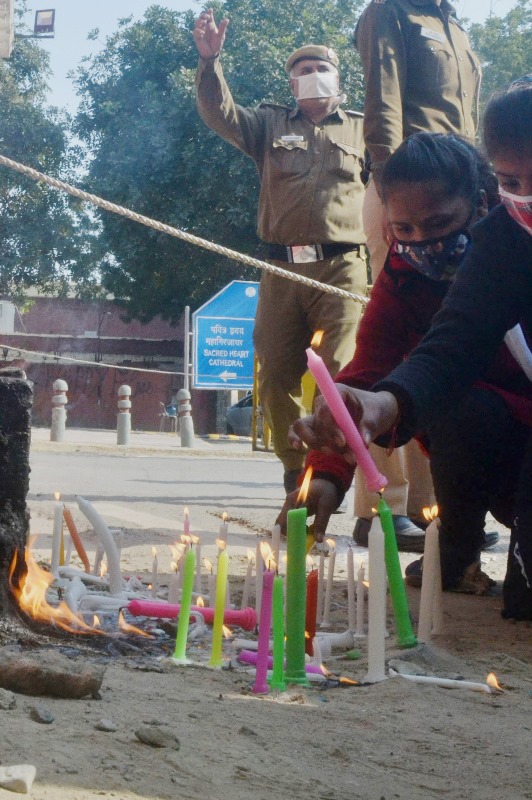 New Delhi: Christian devotees lighting the candles outside Sacred Heart Cathedral Church