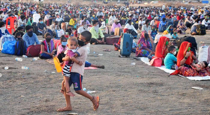 Migrants gather for medical check before boarding in Mumbai