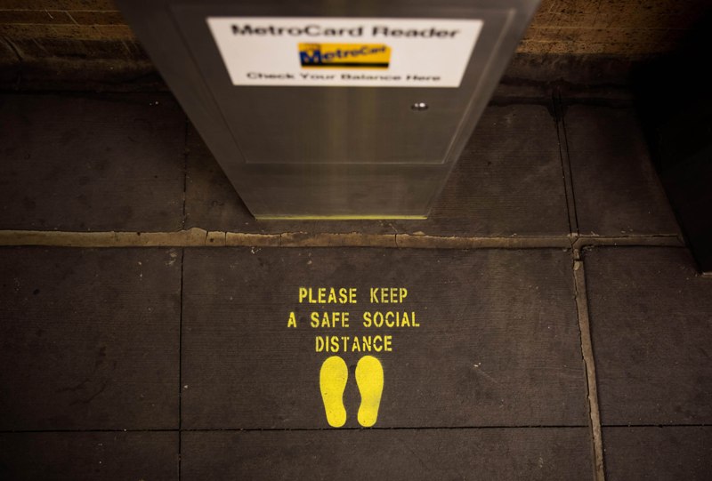 Billboards at Times Square in New York encourage people to maintain social distancing