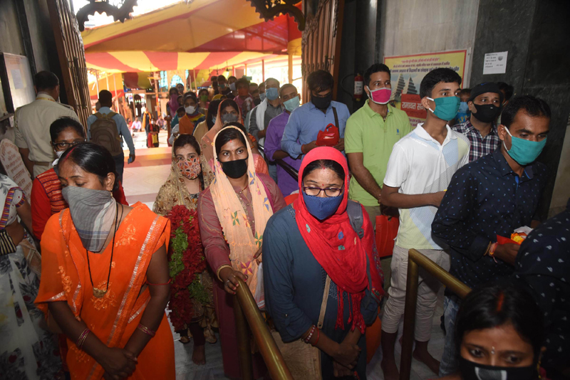 Patna: People wait to enter Mahavir Temple