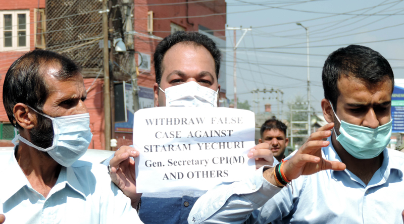 CPI(M) activists agitate demanding withdrawal of cases against party General Secretary Sitaram Yechury
