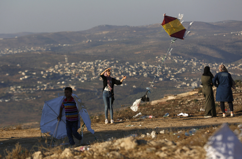 People flying kites on Eid in West Bank city of Nablus