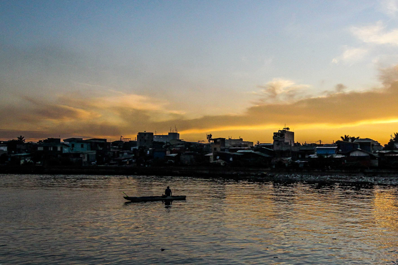 Fisherman prepares to sail on his boat in Manila Bay