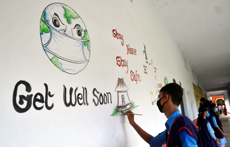 Students create awareness on COVID19 by painting on school wall