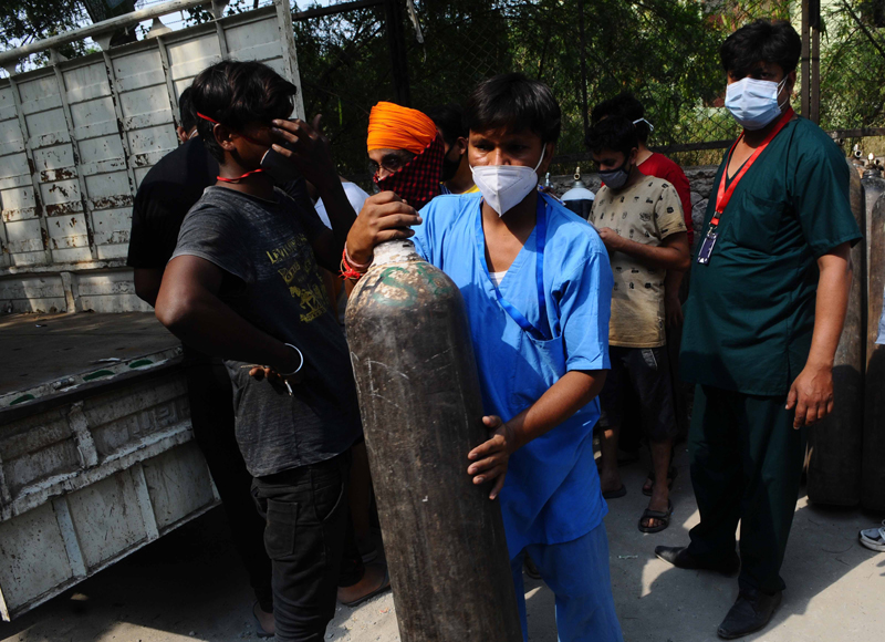 Relatives of COVID-19 patients waiting to get oxygen cylinder refilled