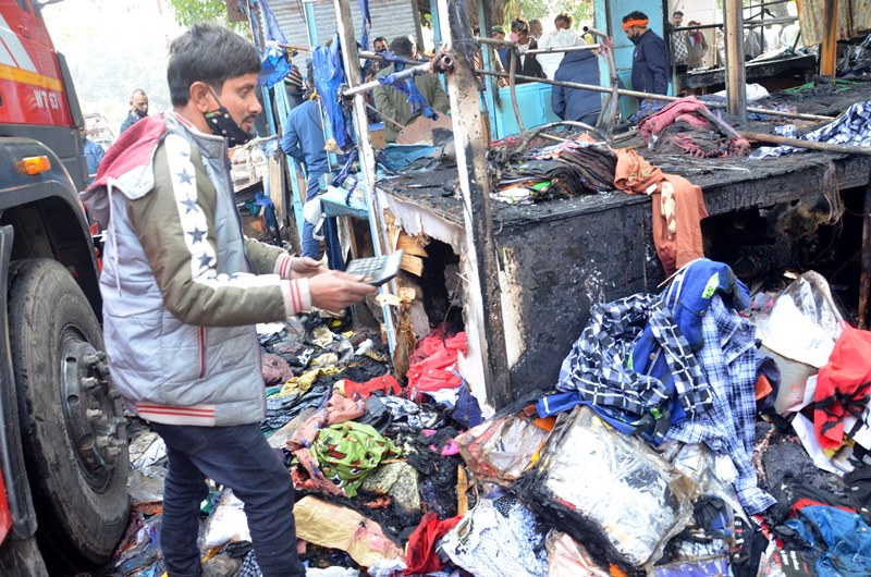Firefighters extinguishing fire at Delhi's Lajpat Rai market