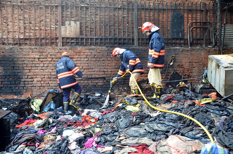 Firefighters extinguishing fire at Delhi's Lajpat Rai market
