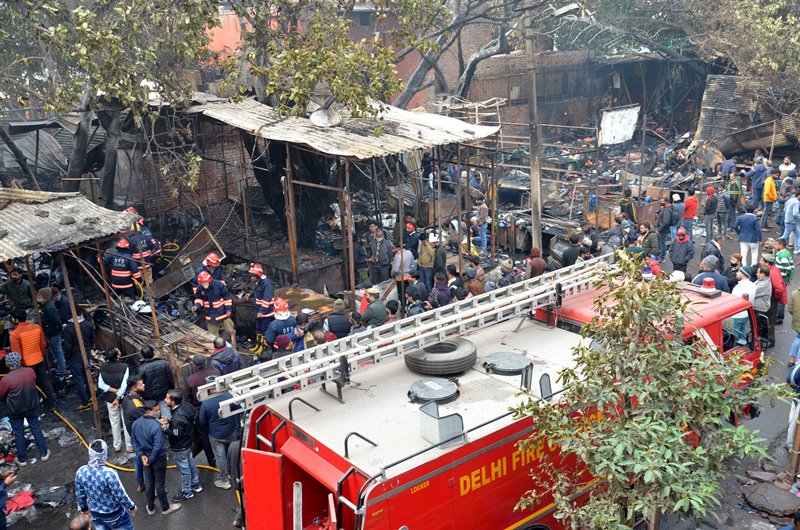 Firefighters extinguishing fire at Delhi's Lajpat Rai market