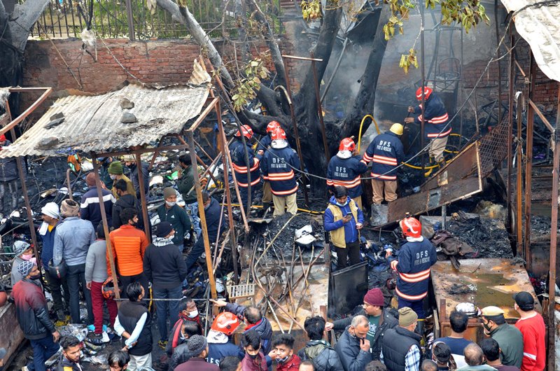 Firefighters extinguishing fire at Delhi's Lajpat Rai market