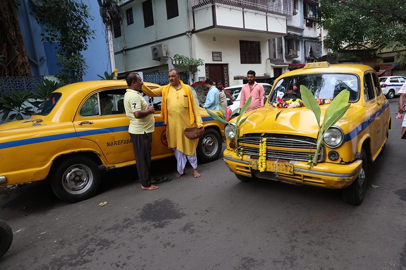 Priest offers prayers to taxi during Vishwakarma Puja in Kolkata