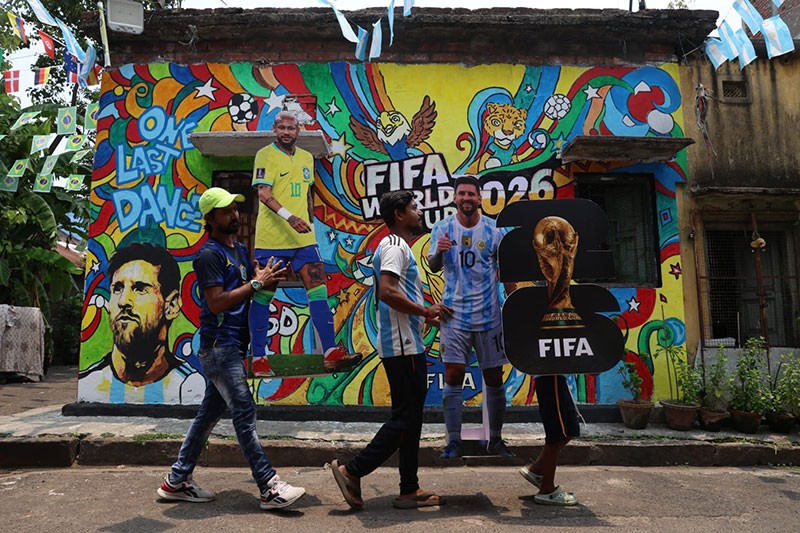 In Images: Children in Kolkata play against the backdrop of a giant World Cup masterpiece