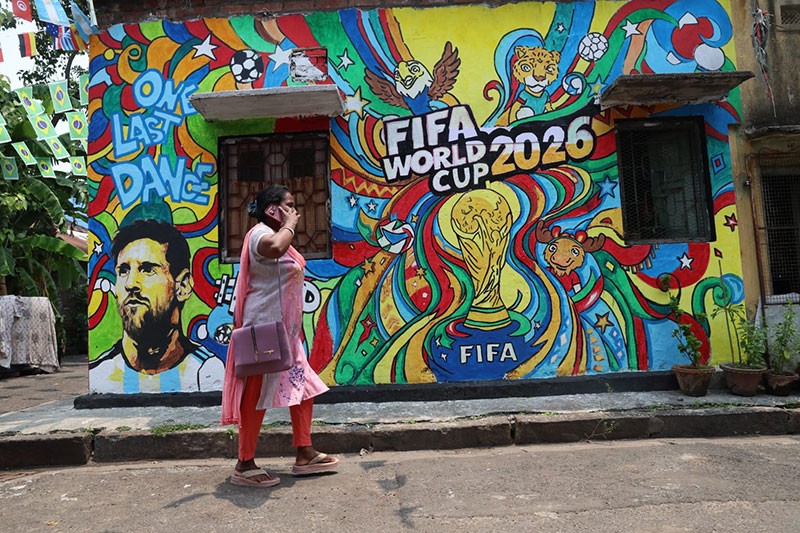In Images: Children in Kolkata play against the backdrop of a giant World Cup masterpiece
