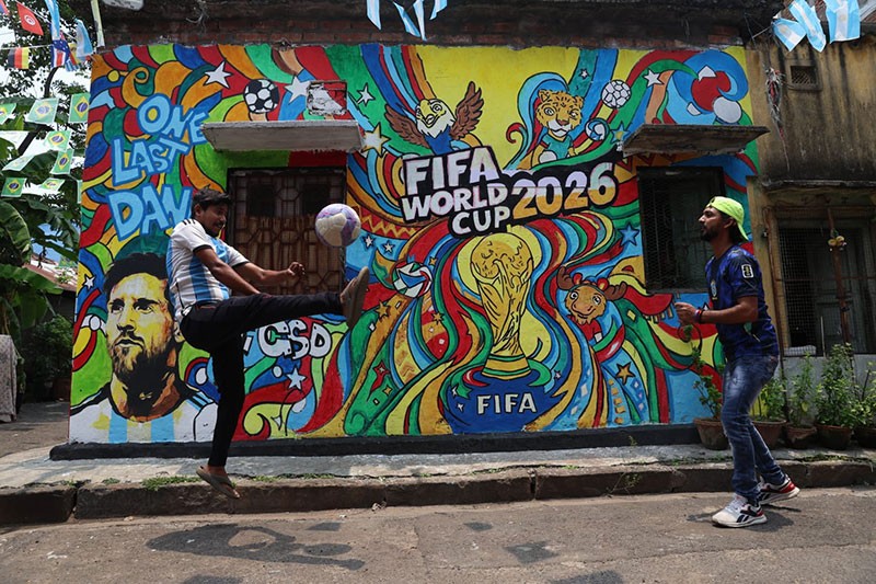 In Images: Children in Kolkata play against the backdrop of a giant World Cup masterpiece