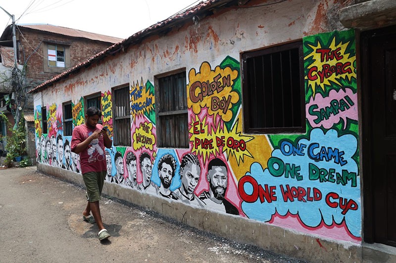 In Images: Children in Kolkata play against the backdrop of a giant World Cup masterpiece
