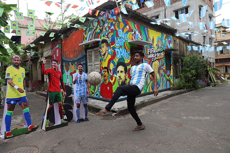 In Images: Children in Kolkata play against the backdrop of a giant World Cup masterpiece