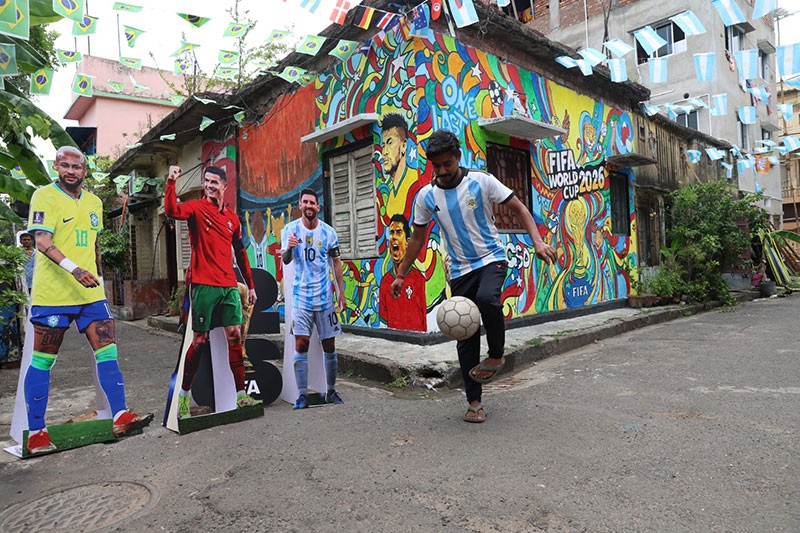 In Images: Children in Kolkata play against the backdrop of a giant World Cup masterpiece