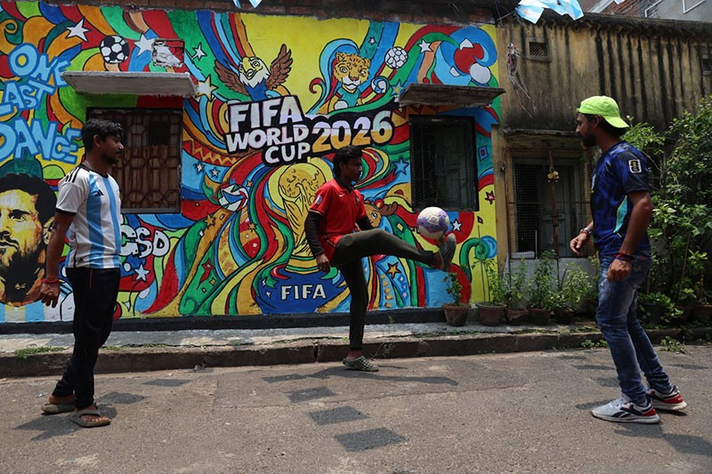 In Images: Children in Kolkata play against the backdrop of a giant World Cup masterpiece