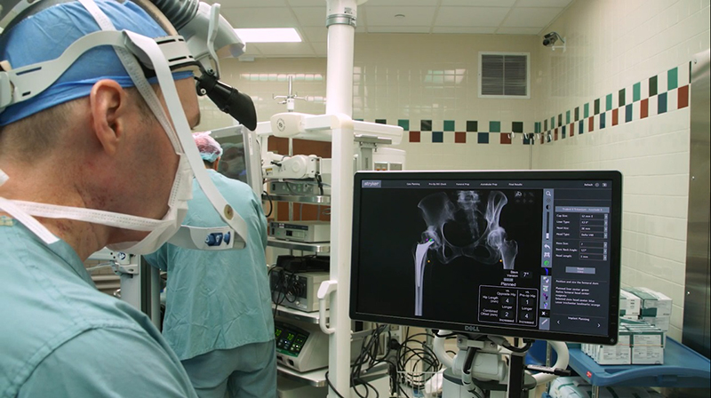 Doctor Jason Davis looks at an X-ray image of a patient’s hips to determine the next steps in the process at Henry Ford Hospital in Detroit. Photos provided by Henry Ford Health Orthopedics. 