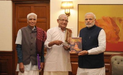 Two scientists presents book to PM Modi