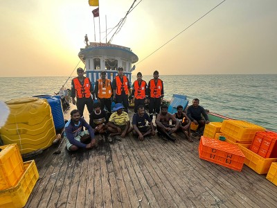 Indian Coast Guard members rescue 8 crew members from a flooded boat