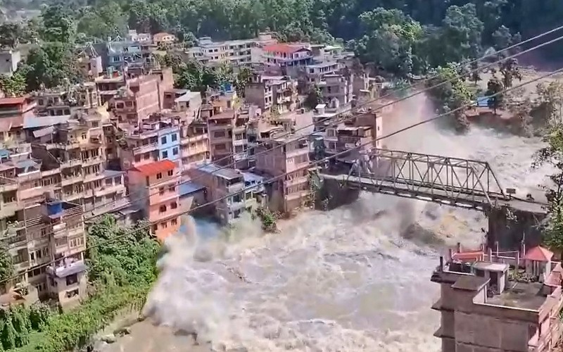 China has warned that an upstream barrier lake could breach as rescue teams search for hundreds missing.
