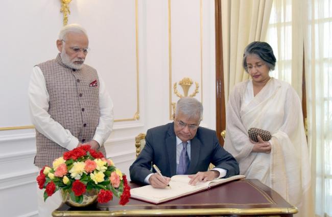 Wickremesinghe signing the visitorsâ€™ book, at Hyderabad House, in New Delhi