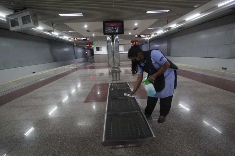 Lucknow Metro employee sprays disinfectants inside coaches at Hazratganj station