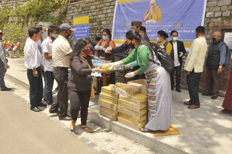 Shimla: Dalai Lama followers distribute masks, sanitizers and juice