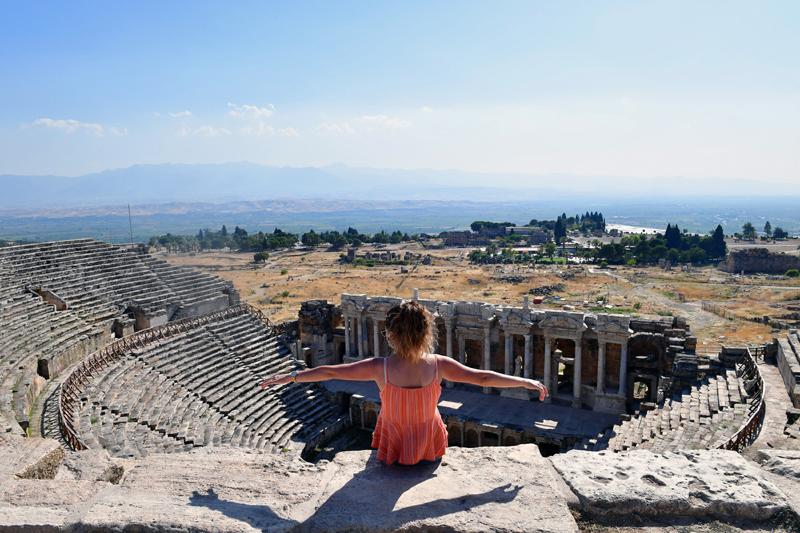 Turkey: A visitor sits on the ruins of the ancient city of Hierapolis