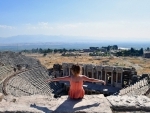 Turkey: A visitor sits on the ruins of the ancient city of Hierapolis