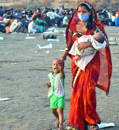 Migrants gather for medical check before boarding in Mumbai