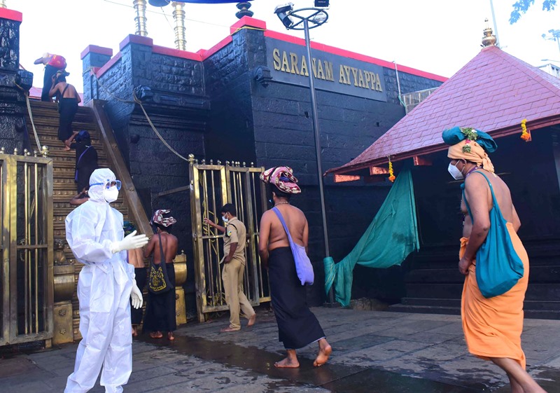 Devotees maintain social distancing and wait for prayers during Mandala Makaravilakku in Sabarimala temple