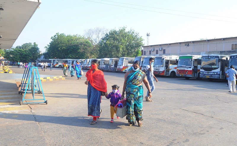 Commuters on their way to board the buses during Bharat Bandh in Vijayawada