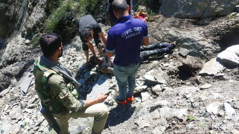 Police and Civil Defence team members retrieving body of a boy died in Ramban accident