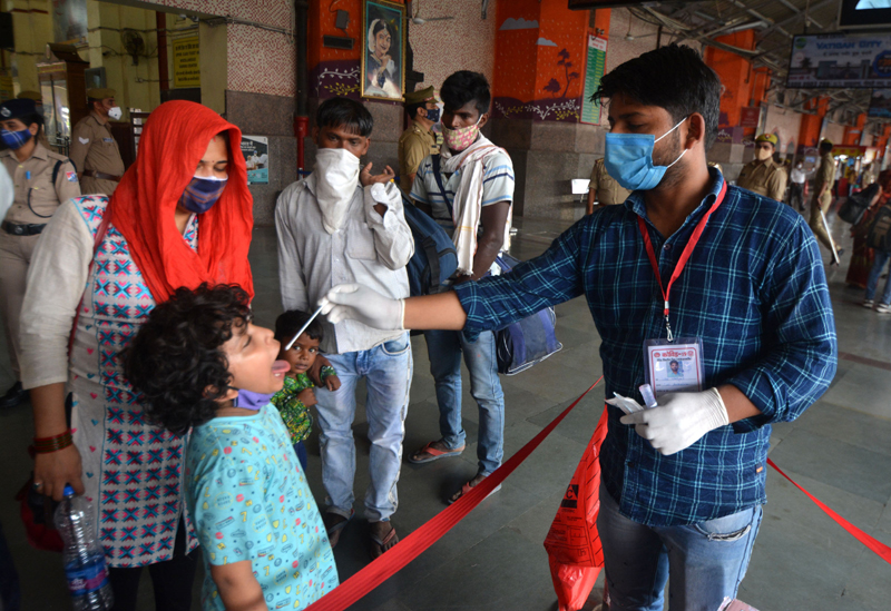 Lucknow: A medico collecting swab sample for Covid 19 test