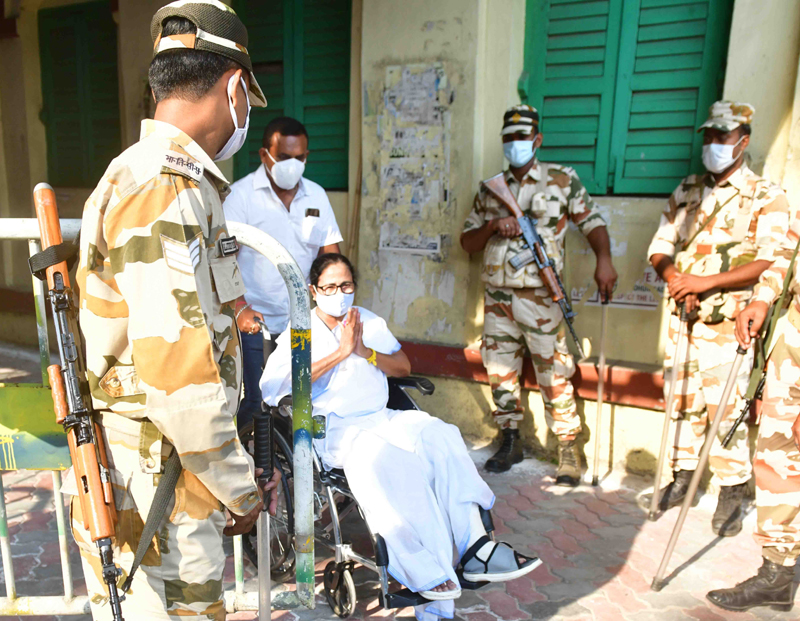 Mamata Banerjee sports a victory sign after casting her vote today