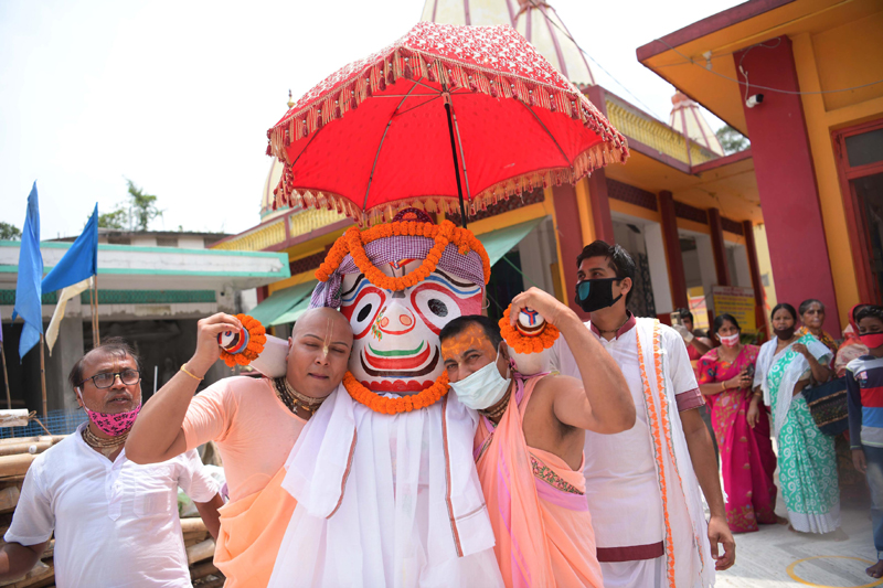 Hindu priests performing rituals during the Snana Yatra of of Lord Jagannath,Subhadra and Balabhadra