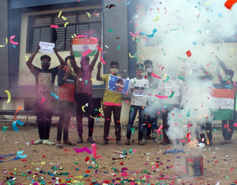 People in India celebrate India's historic win in Australia