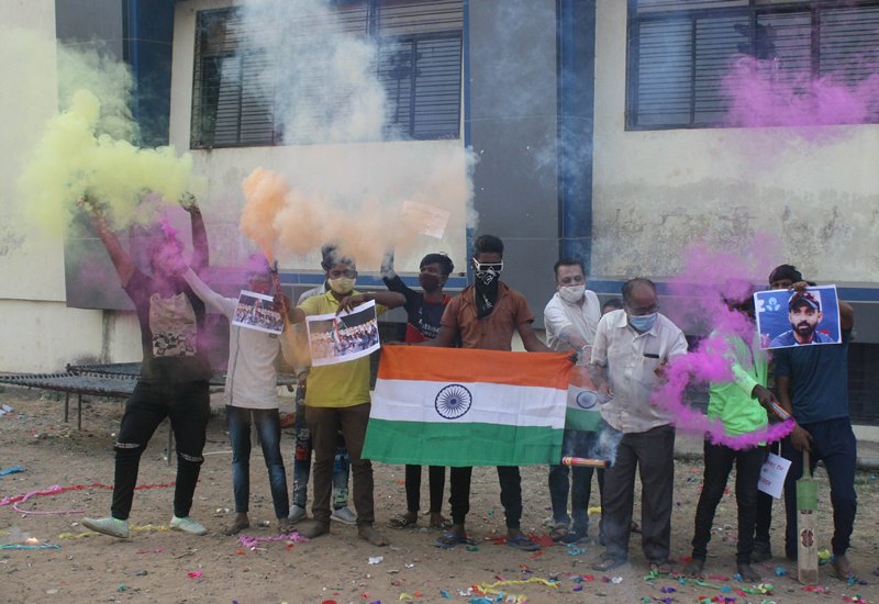 People in India celebrate India's historic win in Australia