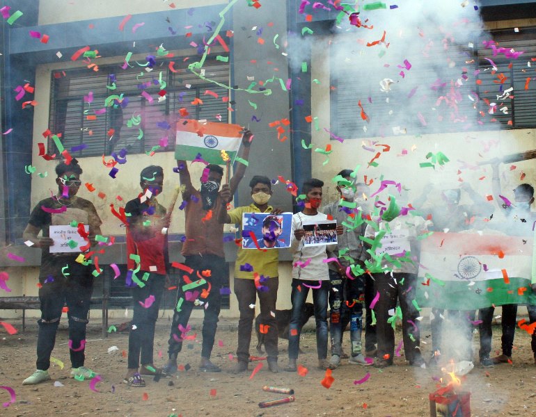 People in India celebrate India's historic win in Australia