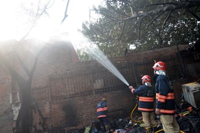 Firefighters extinguishing fire at Delhi's Lajpat Rai market