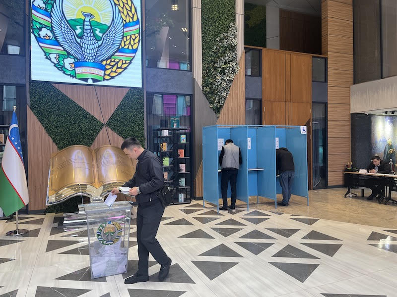 A younger voter casts his ballot in a polling booth in Tashkent. Photo by Sujoy Dhar